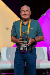 Man smiling holding award